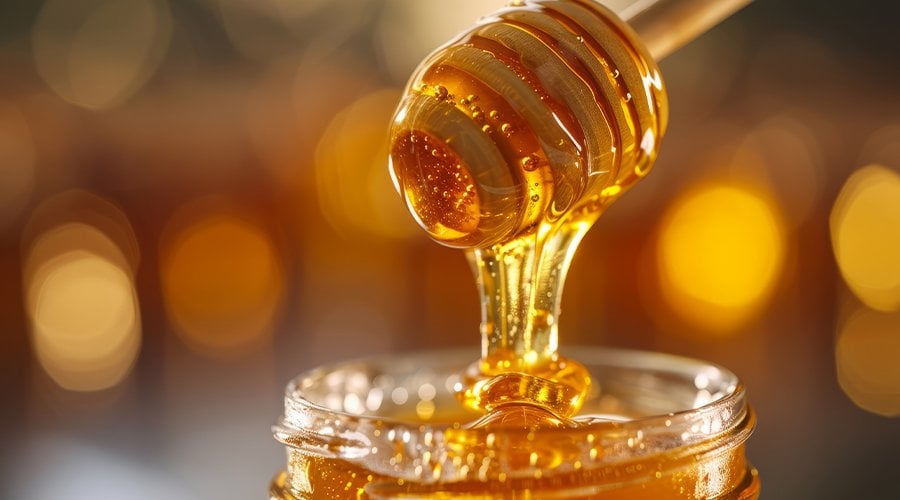 Herbal honey being taken directly.